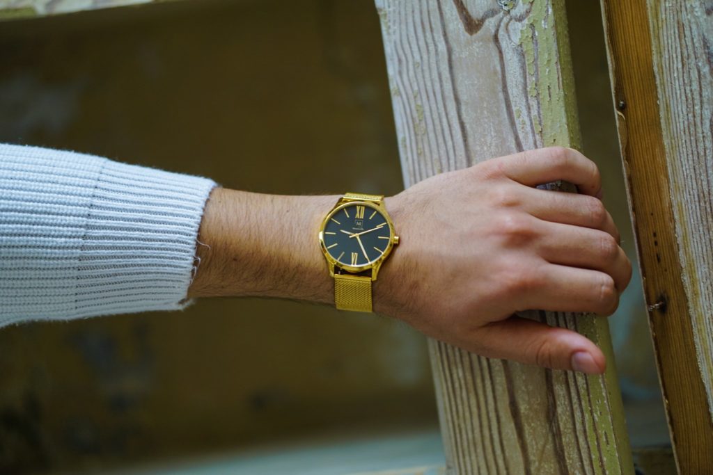 a golden watch on a man's wrist